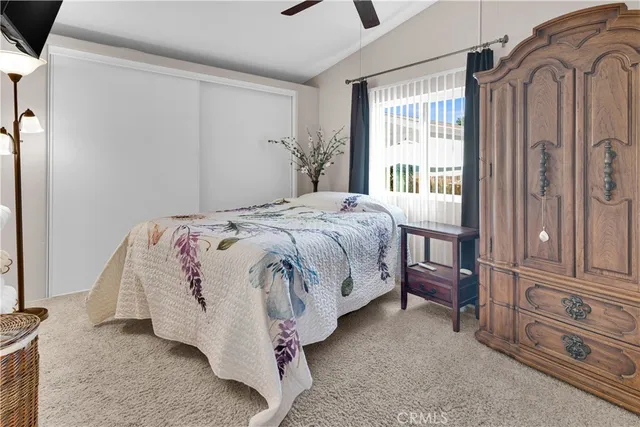 a bed sitting in a bedroom next to a window