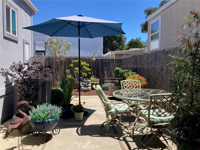 a view of a tables and chairs under an umbrella in patio