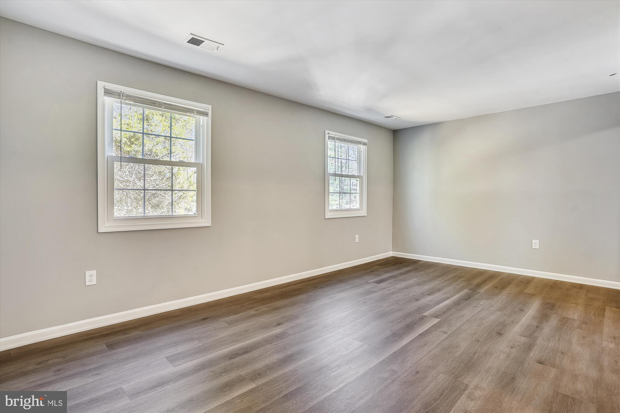 9202 Sprucewood Road Burke, VA 22015 - Photo 10 of 21 a view of an empty room with wooden floor and a window