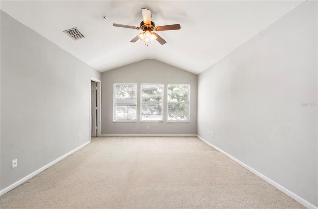 3151 Sinclair Street, Unit 101 Orlando, FL 32835 - Photo 11 of 18 wooden floor in an empty room with a window