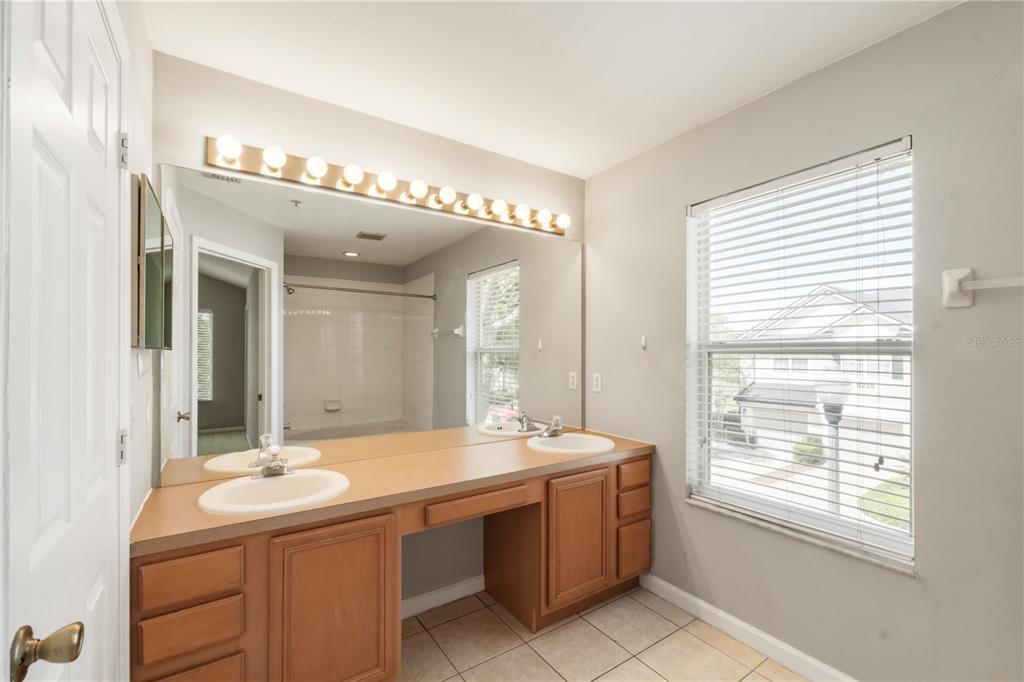 3151 Sinclair Street, Unit 101 Orlando, FL 32835 - Photo 14 of 18 a bathroom with a sink and a mirror