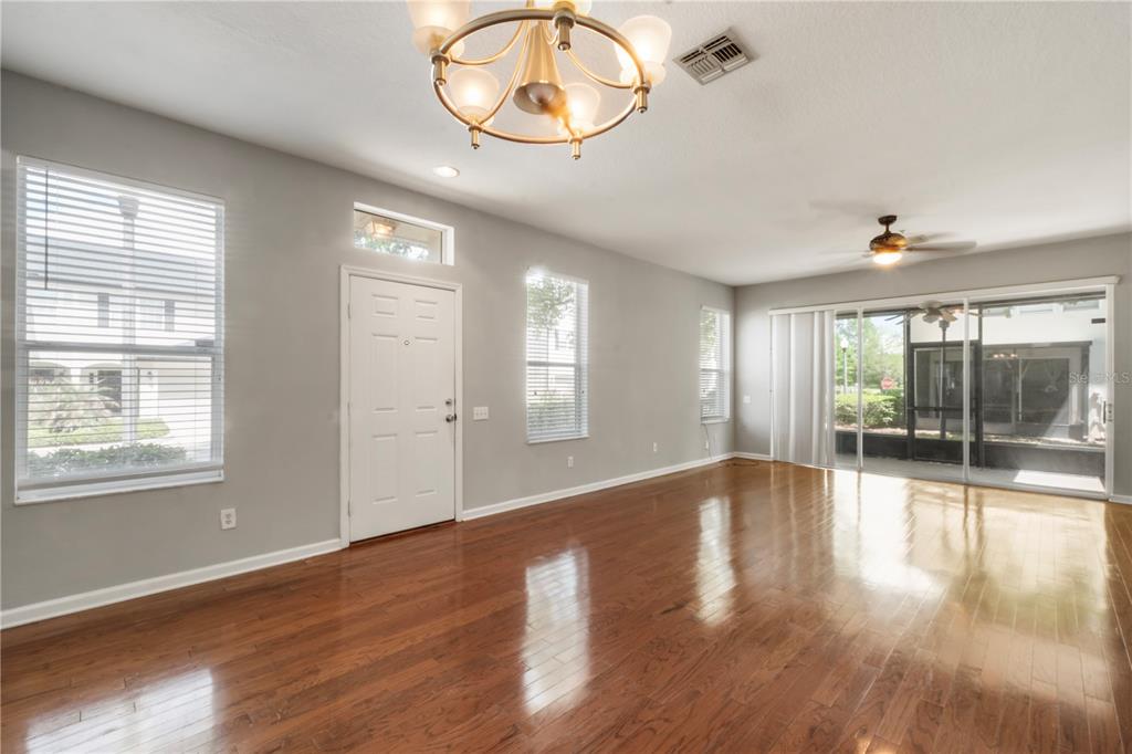3151 Sinclair Street, Unit 101 Orlando, FL 32835 - Photo 2 of 18 an empty room with wooden floor and windows
