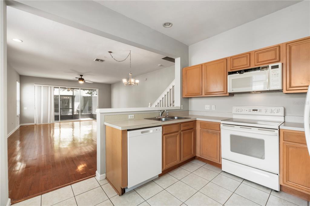 3151 Sinclair Street, Unit 101 Orlando, FL 32835 - Photo 5 of 18 a kitchen with stainless steel appliances granite countertop a stove and a sink