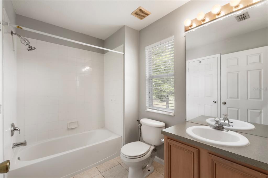 3151 Sinclair Street, Unit 101 Orlando, FL 32835 - Photo 9 of 18 a bathroom with a sink toilet tub vanity and shower