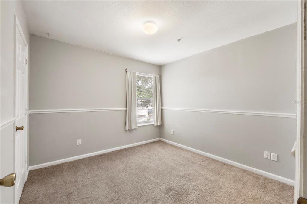 3151 Sinclair Street, Unit 101 Orlando, FL 32835 - Photo 10 of 18 an empty room with windows