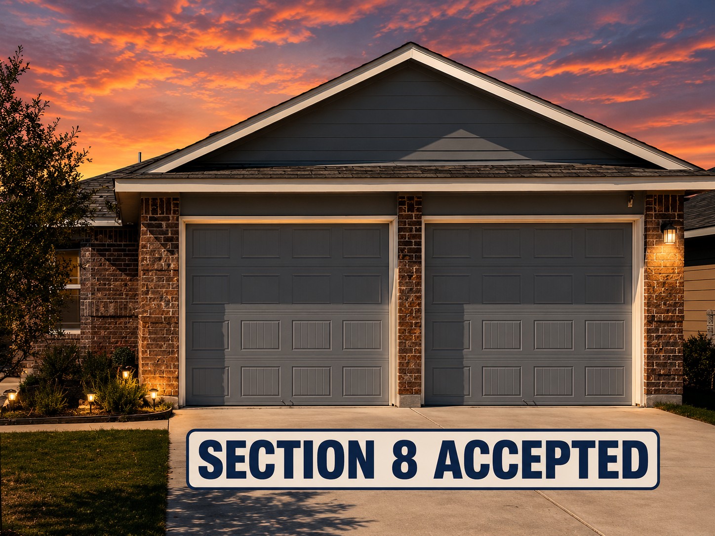 13004 Tinker Street Manor, TX 78653 - Photo 2 of 9 A striking sunset illuminates the facade of this home, showcasing its two-car garage and brick accents.