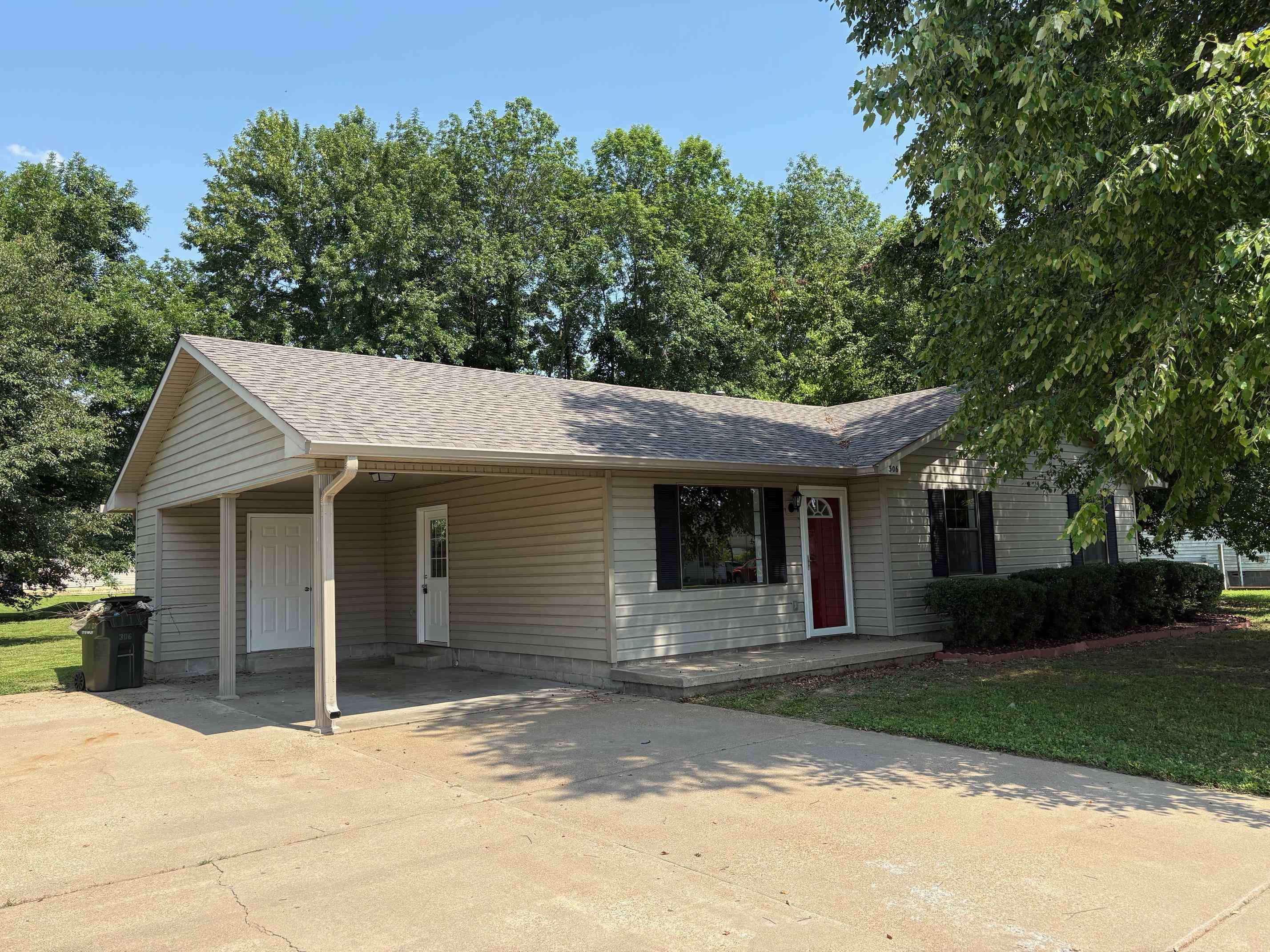306 Robin Drive Ripley, TN 38063 - Photo 1 of 17 a backyard of a house with plants and trees