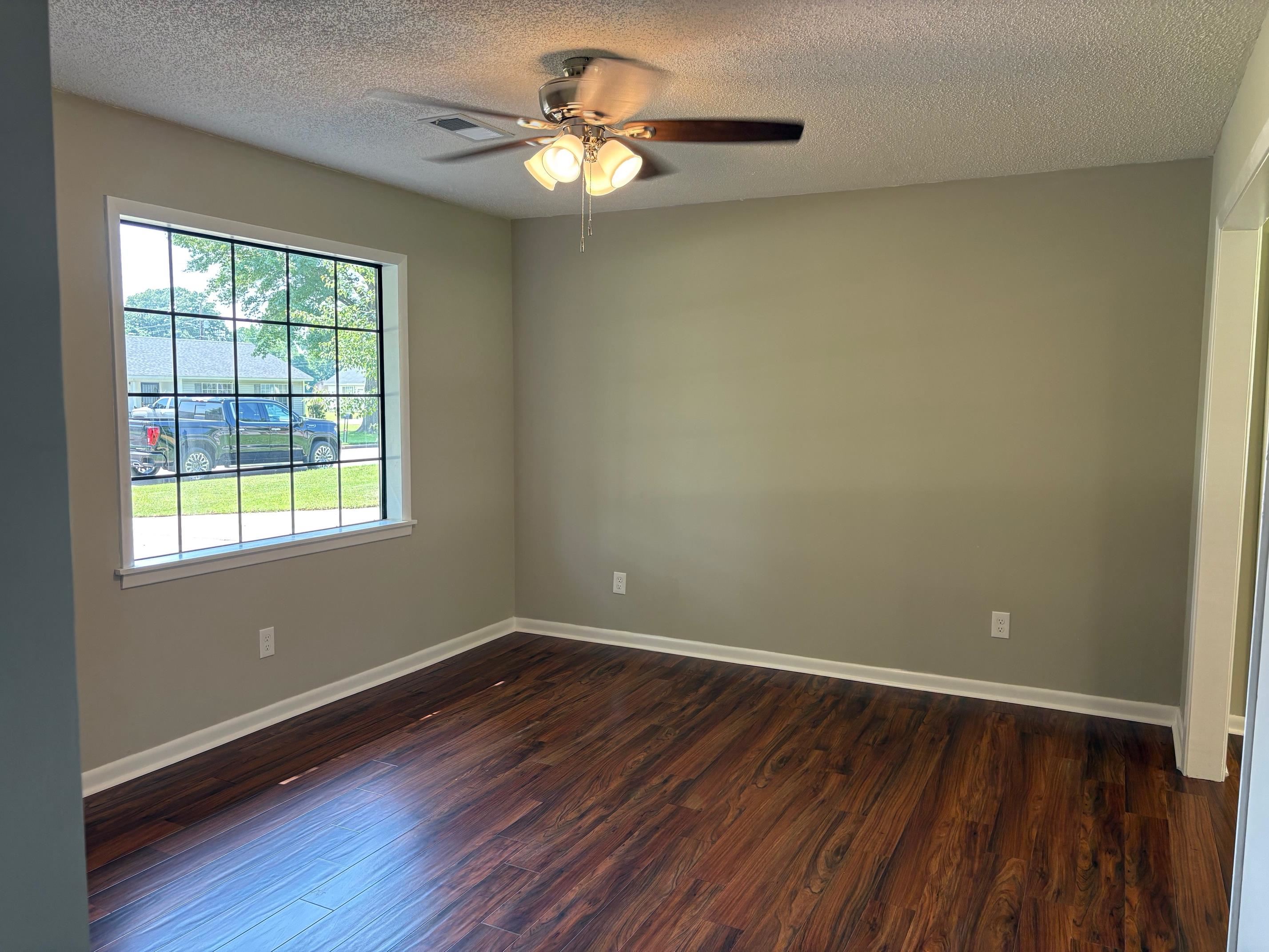 306 Robin Drive Ripley, TN 38063 - Photo 17 of 17 a view of wooden floor and a chandelier fan in a room