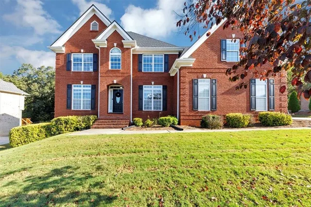 a front view of a house with yard and garage