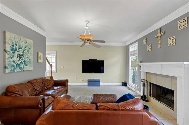 a living room with furniture a fireplace and a flat screen tv