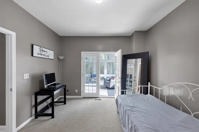 a bedroom with a bed and large window