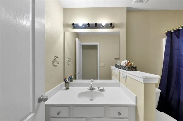a bathroom with a sink a mirror and a toilet