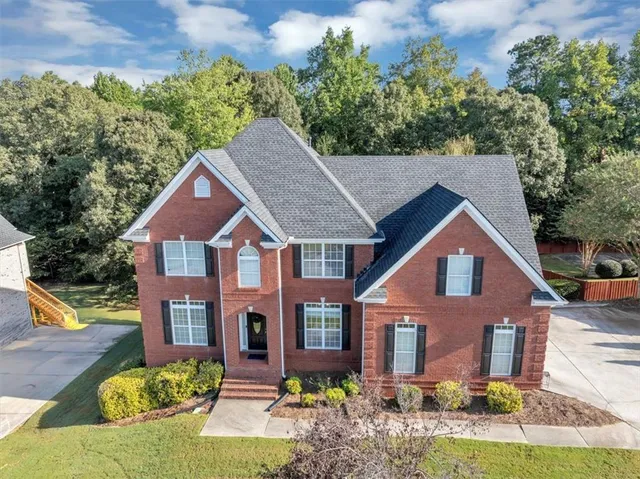 a front view of a house with a yard