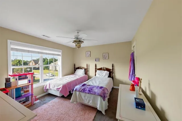 a bedroom with bed and a large window