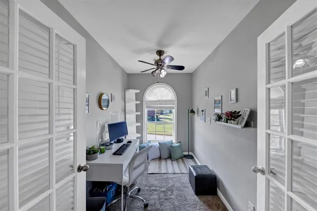 a living room with furniture a fireplace and a chandelier