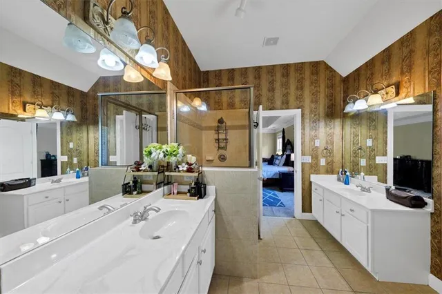a bathroom with a sink mirror and a bathtub