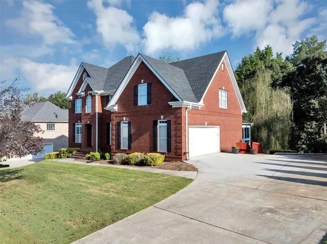 a front view of a house with a yard
