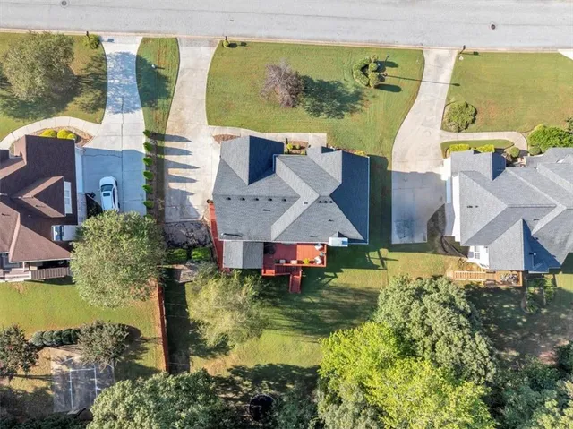 an aerial view of residential houses with outdoor space and swimming pool