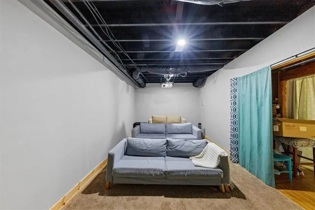 a view of an empty room with wooden floor and a cabinet