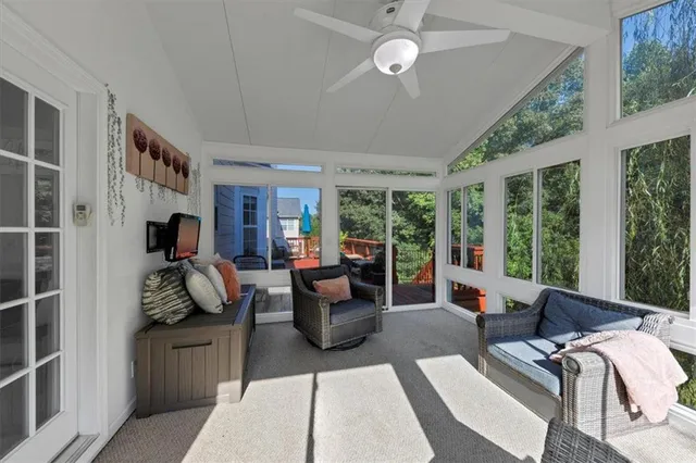 a balcony with wooden floor and outdoor seating