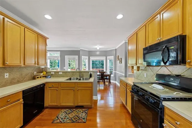 a kitchen with a sink stove and cabinets