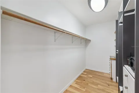 a view of a room with wooden floor and bathroom
