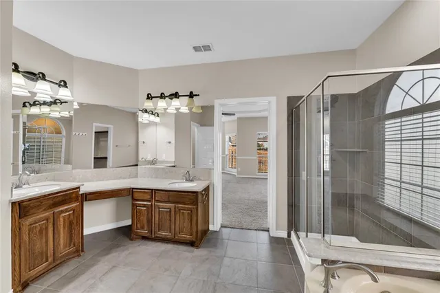 a view of an empty room with window and cabinet
