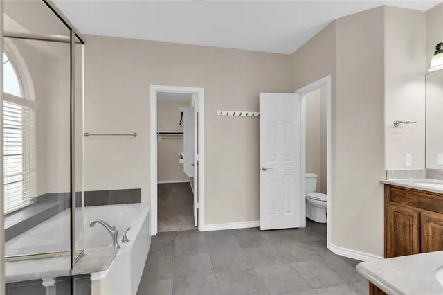 a bathroom with a bathtub and a shower