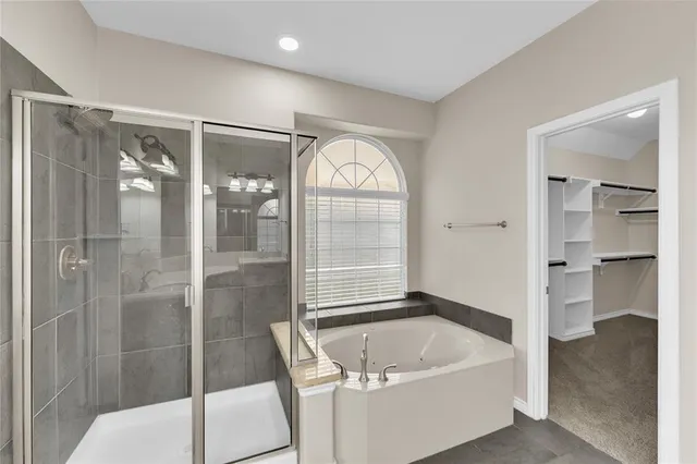 an empty room with closet and windows