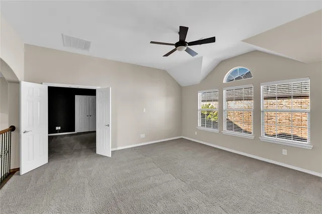 a view of a hallway with a chandelier fan