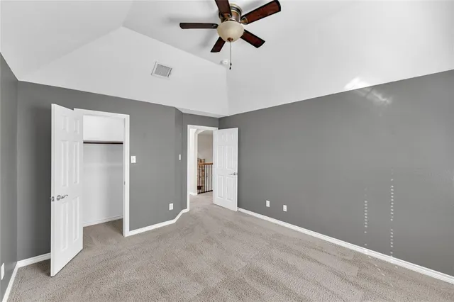 a view of a livingroom with a ceiling fan and window