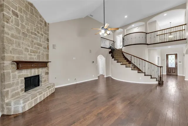 a view of a livingroom with wooden floor and a fireplace