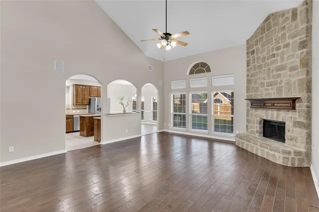a view of a livingroom with furniture chandelier fan and fireplace
