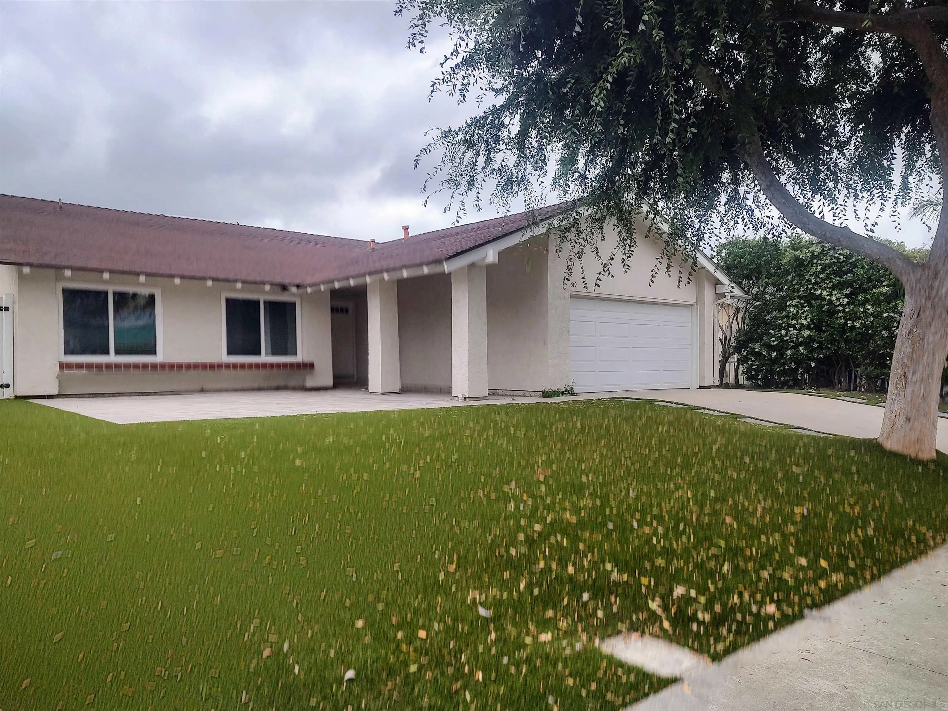a view of a house with a backyard