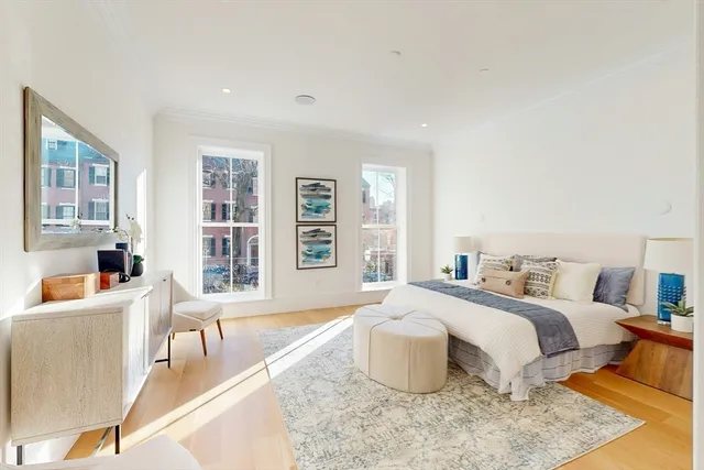 a bedroom with a bed and a chair