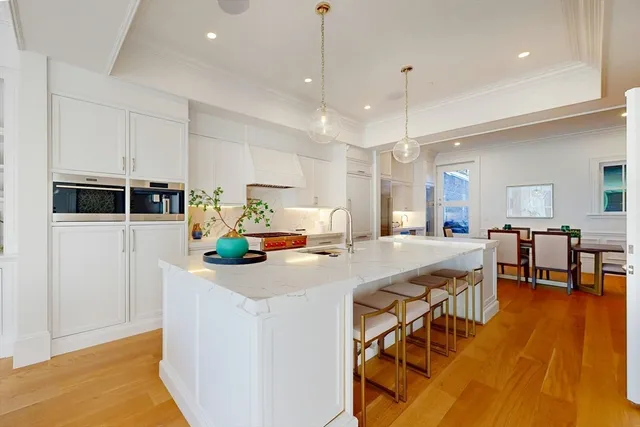 a kitchen that has a lot of cabinets a sink and appliances in it