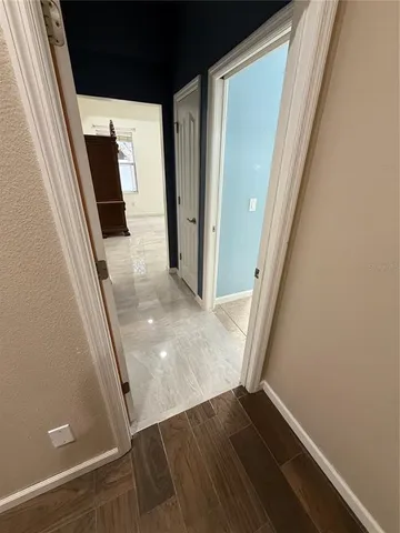 a spacious bathroom with a granite countertop sink a bathtub and window
