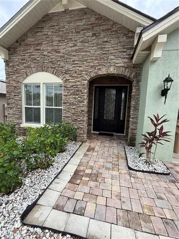 a front view of a house with a garden