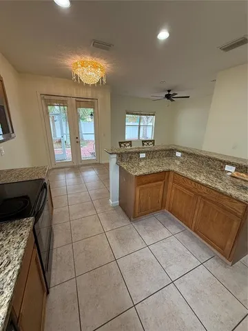 a kitchen with a stove top oven and cabinets