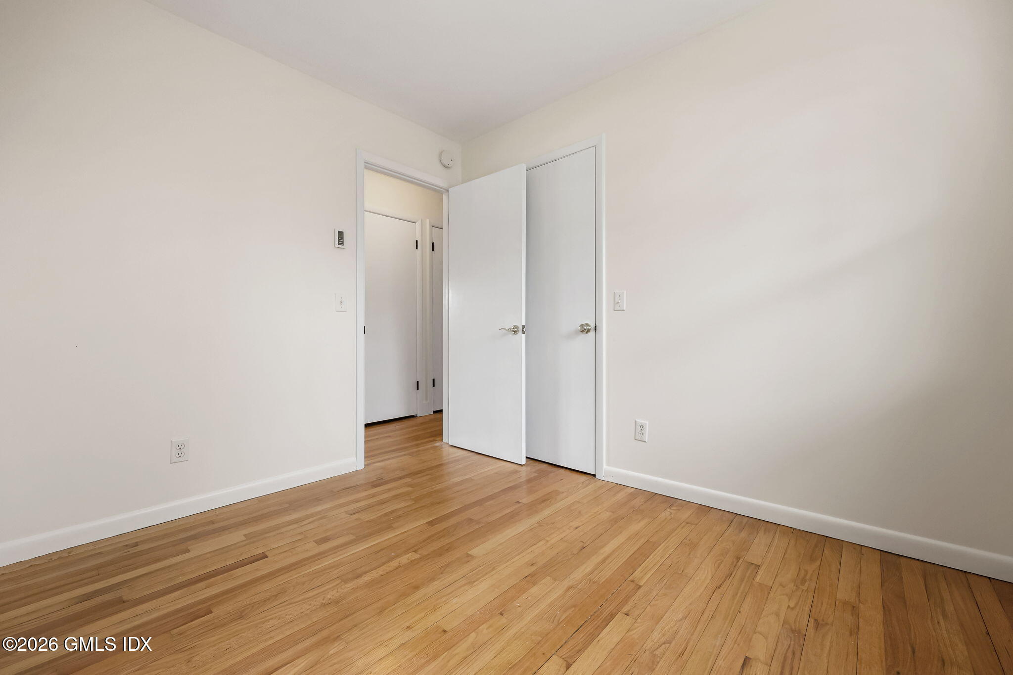 2 Grange Street Greenwich, CT 06830 - Photo 22 of 31 a view of an empty room with wooden floor