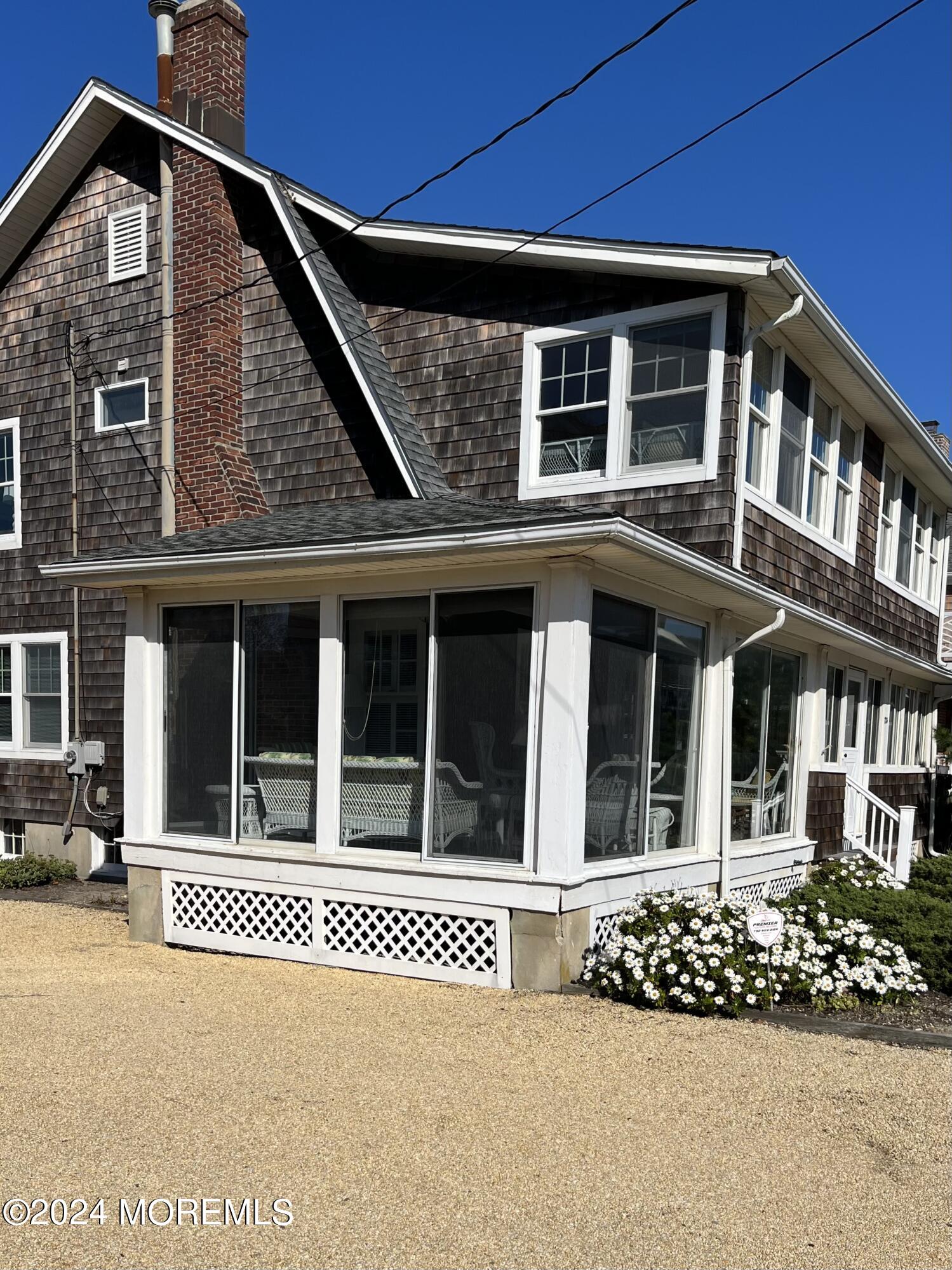 724 East Avenue, Unit SUMMER Bay Head, NJ 08742 - Photo 1 of 16 a front view of a house with a garden