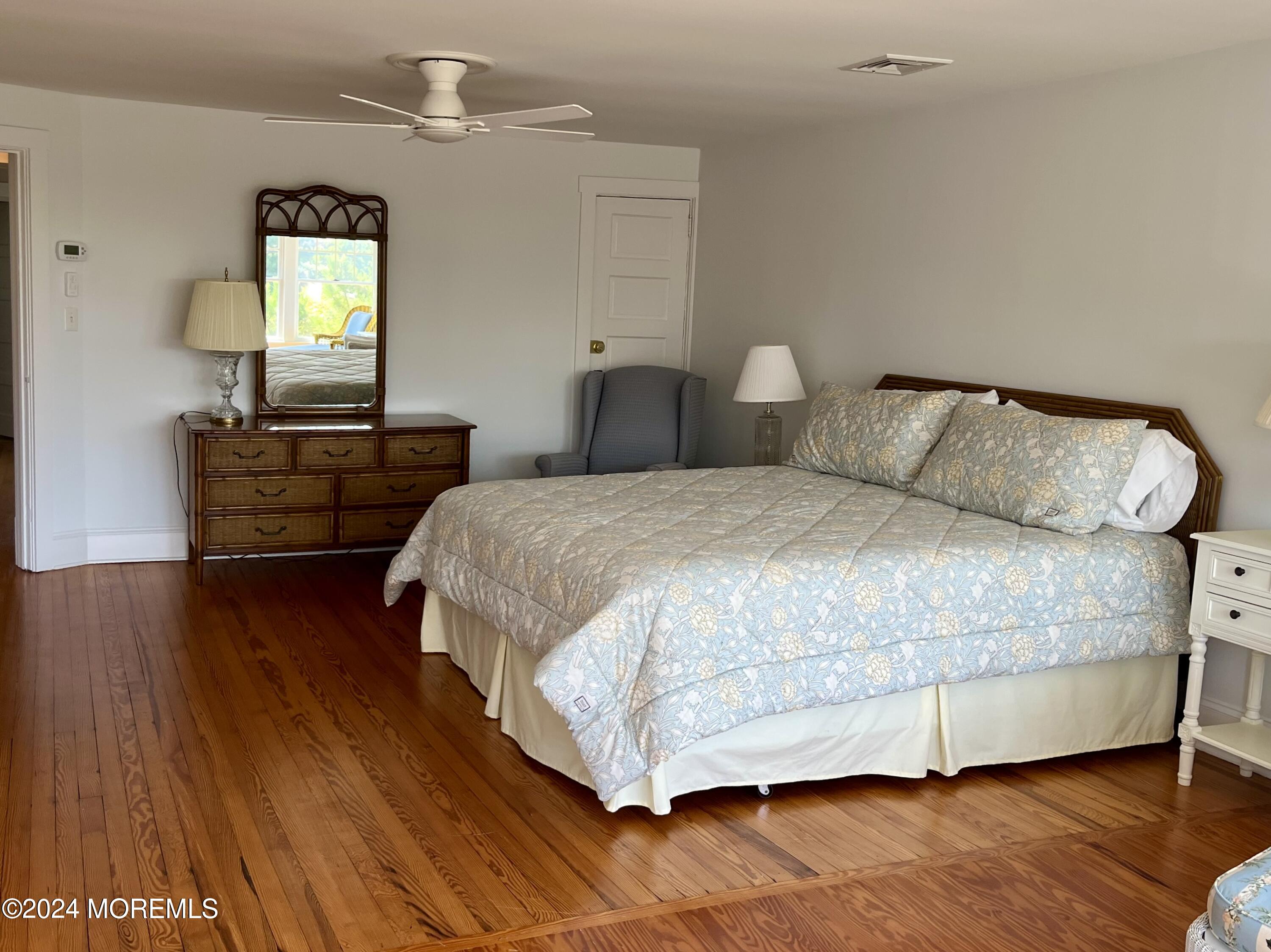724 East Avenue, Unit SUMMER Bay Head, NJ 08742 - Photo 13 of 16 a bedroom with a bed and wooden floor