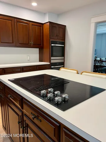 a kitchen with wooden cabinets and stainless steel appliances