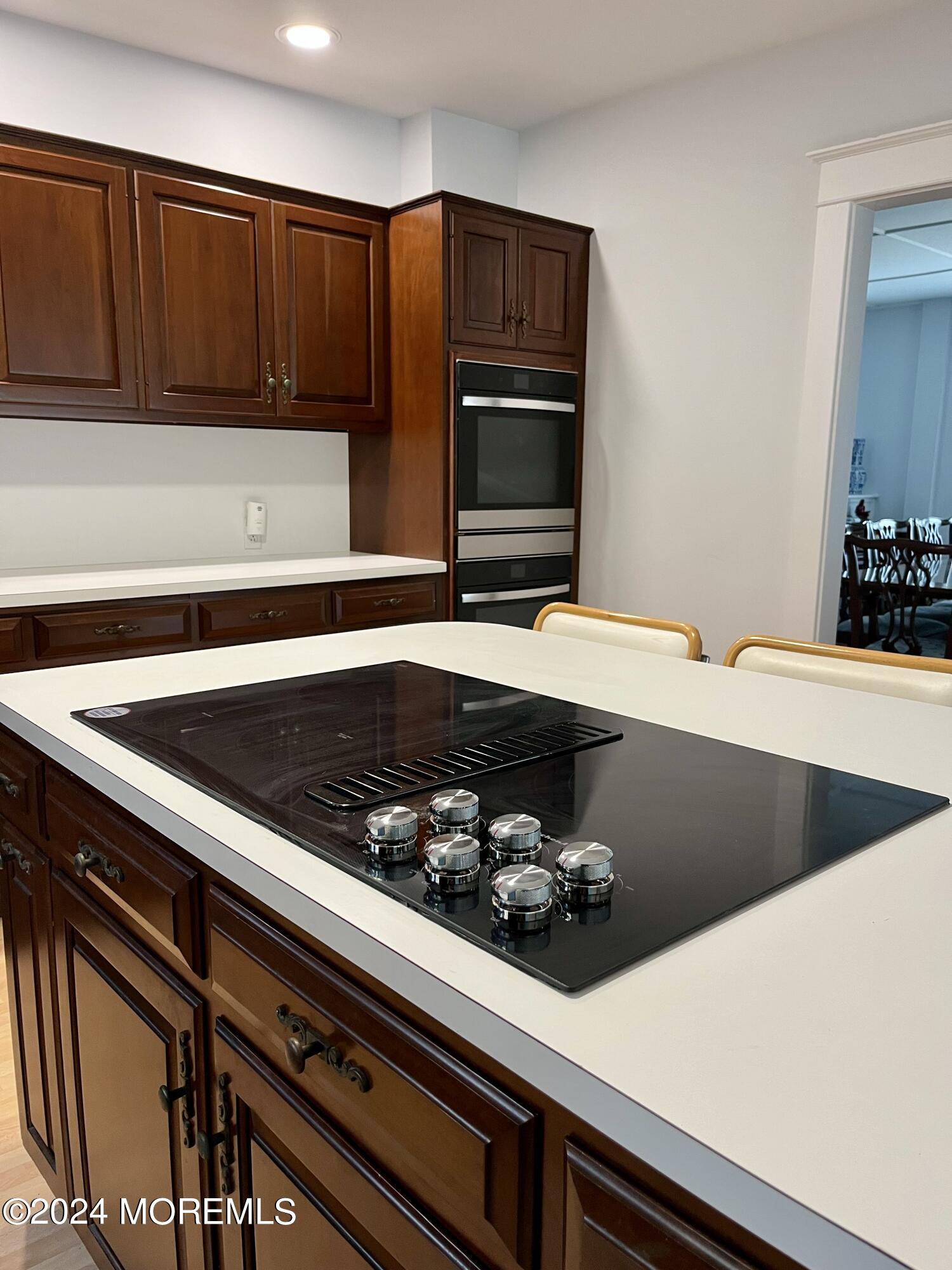 724 East Avenue, Unit SUMMER Bay Head, NJ 08742 - Photo 8 of 16 a kitchen with wooden cabinets and stainless steel appliances