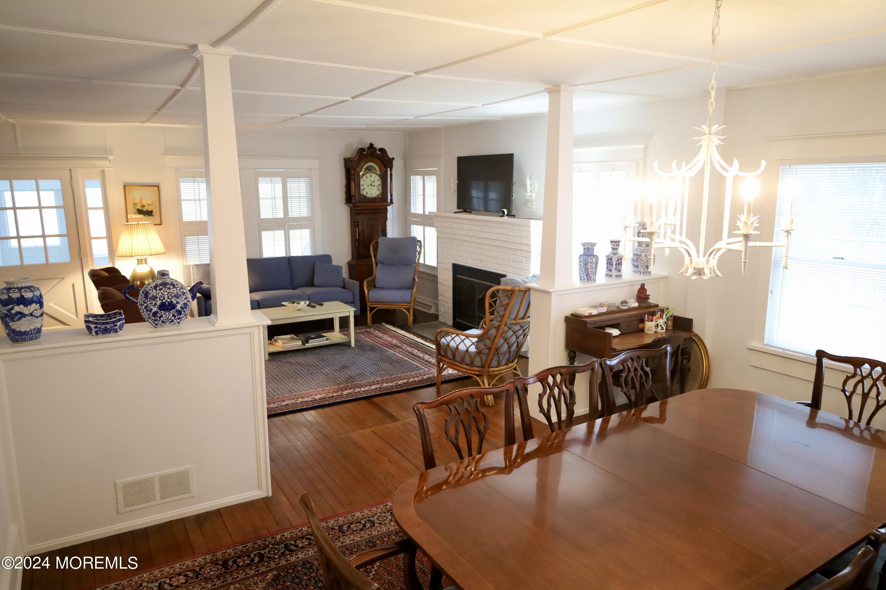 724 East Avenue, Unit SUMMER Bay Head, NJ 08742 - Photo 9 of 16 a living room with furniture dining table and a fireplace
