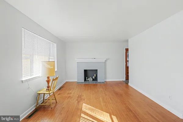 a view of a livingroom with a fireplace and window
