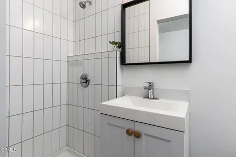 a bathroom with a sink and mirror