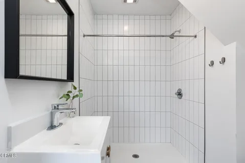 a bathroom with a shower and a sink