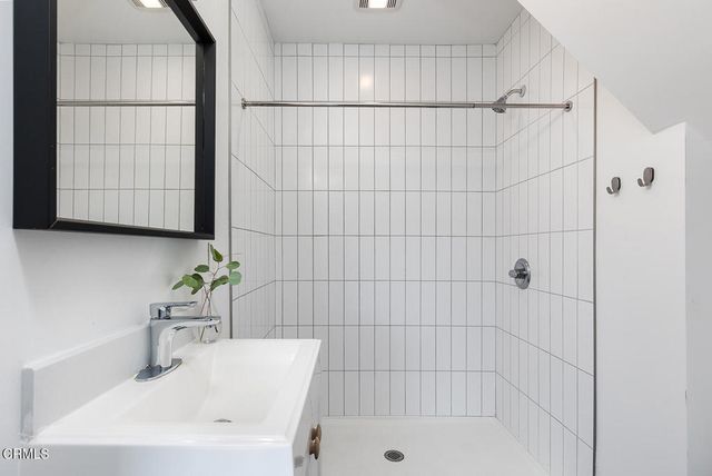 a bathroom with a shower and a sink