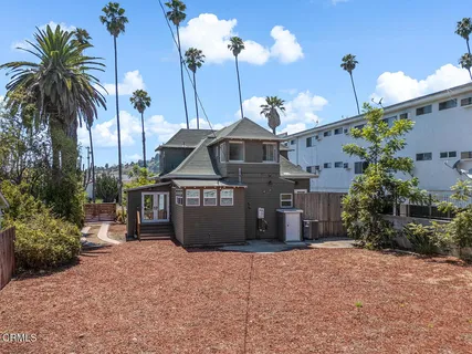 a front view of a house with yard and parking